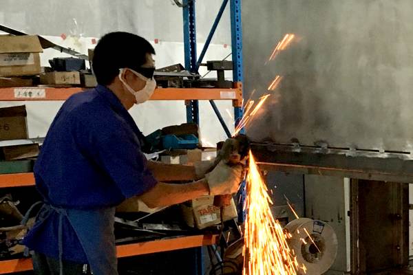 Person grinding on a versa cabinet frame